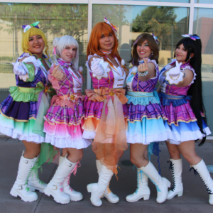 Photo of the idol group Irodori Idols, posing together while doing the small finger hearts gesture towards the camera.